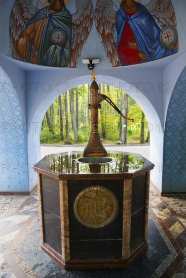 Ornamented fountain in an interior with angel paintings and forest view, Fountain of the Holy Spring, Grabarka, Powiat Siemiatycze, Podlaskie Voivodeship, Podlaskie, Poland