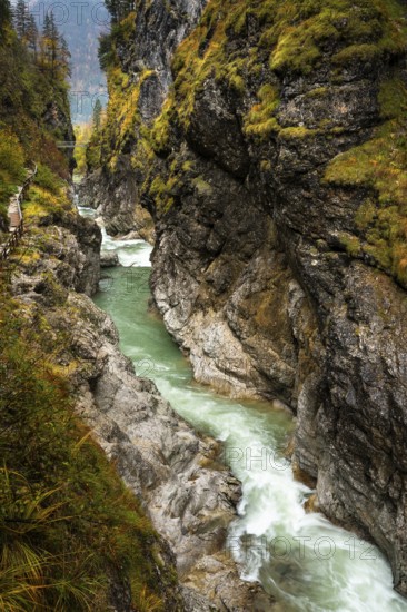 The river Lammer in the gorge Lammerklamm (Lammeröfen) . A path leads through the gorge on the left. In the background the High Bridge, a footbridge over the gorge. Autumn. Scheffau, Lammertal, Salzburger Land, Upper Austria, Austria