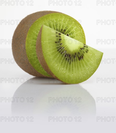 Half a kiwi and a kiwi slice, kiwi, kiwi fruit, Chinese gooseberry (Actinidia deliciosa) against a white background, studio shot
