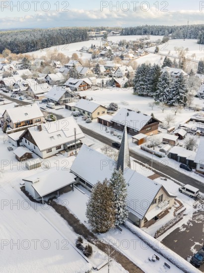 Snow-covered roofs and church in a wintry village, Oberreichenbach, Black Forest, Calw district, Germany