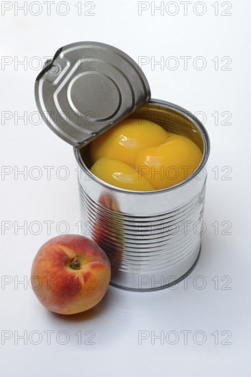 Peach, preserved peach halves with syrup in a tin can