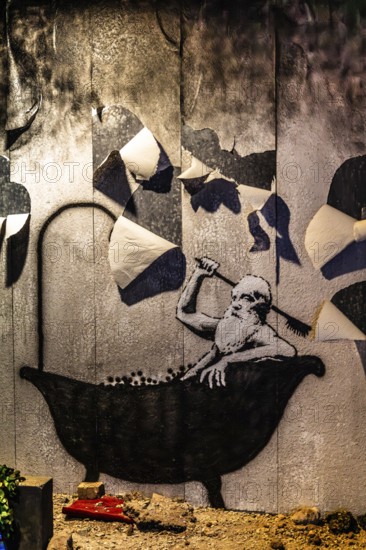 Banksy - Bad in Truemmern, painting on a destroyed house wall in Kiev, Ukraine, exhibition The World of Banksy
