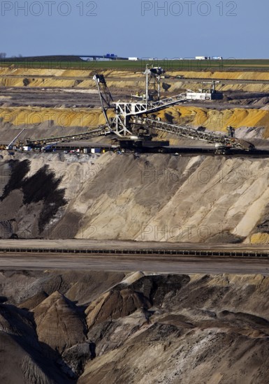 Opencast lignite mine with spreader and motorway in the background, Garzweiler, Jüchen, North Rhine-Westphalia, Germany