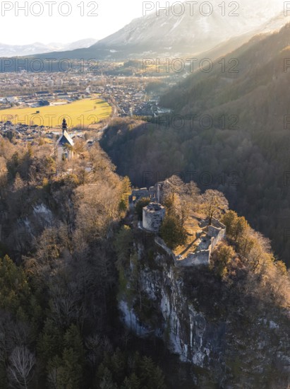 Castle on a rock above a river valley during the golden hour with a gentle hilly landscape in the background, St Pankraz, Karlstein, Bad Reichenhall, Germany