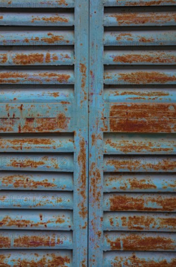 Weathered blue and red window shutter, mountain village Lakkoi, Crete, Greece