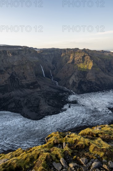 Waterfalls on a cliff, Impressive landscape with mountains and glaciers in the evening light, Huldujökull glacier tongue, Myrdalsjökull glacier, Pakgil, Iceland