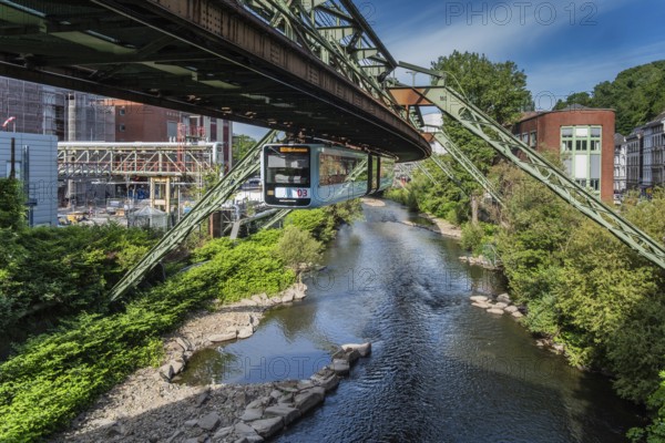 The Wuppertal suspension railway runs through a historic district and industrial area near the Westende stop in Wuppertal, Germany