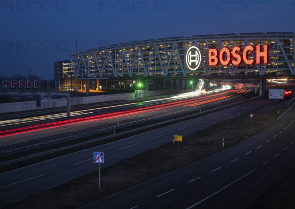 Traffic on the A8 motorway, blue hour, illuminated parking garage, Landesmesse Stuttgart, red-lit Bosch logo, second-largest logo in the world 55 meters wide, Baden-Württemberg, Germany