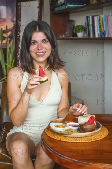 Young woman savoring a traditional filipino breakfast with watermelon, showcasing the vibrant culinary scene of siargao island