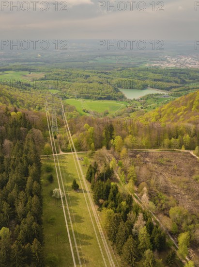 Hilly forest landscape with distant views of power lines and nature, Glems reservoir, Swabian Alb, Germany