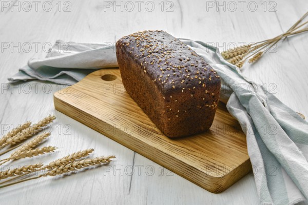 Loaf of brown sourdough bread with sunflower seeds and sesame