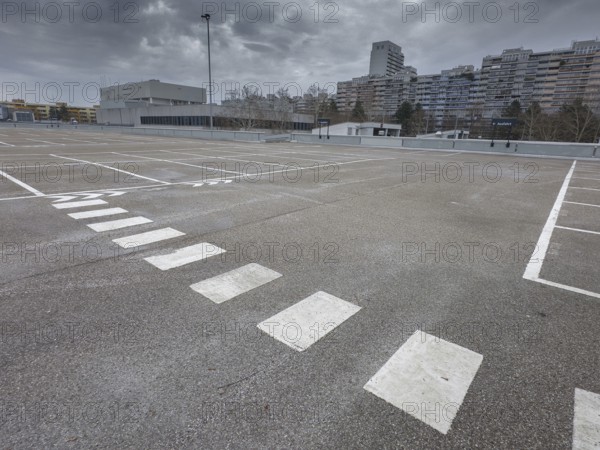 Symbolic image economic crisis, dark clouds in the sky, empty parking deck at Olympia-Einkaufszentrum OEZ, Pelkovenstraße, Munich, Bavaria, Germany