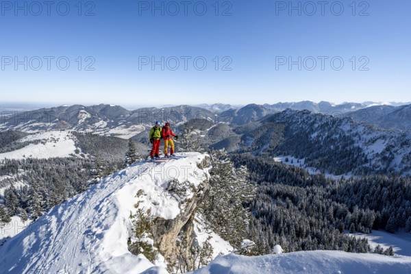Two ski tourers on a mountain ridge, on the ascent to the Teufelsstättkopf, snowy mountain landscape, mountain panorama, Ammergau Alps, Bavaria, Germany