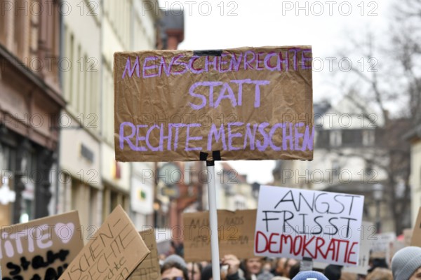 Heidelberg, Germany - February 12th 2025: Person holding up sign with text 'Human rights instead of right people in crowd at protest against far-right