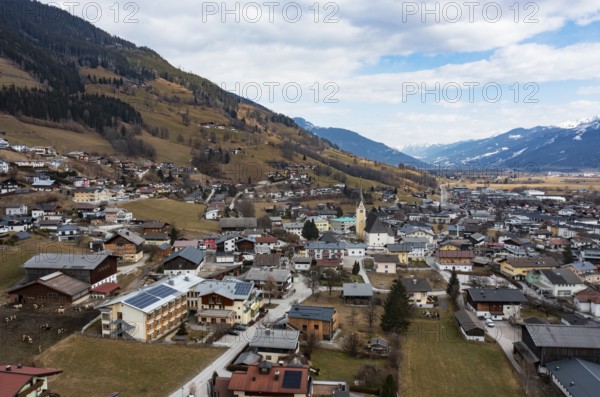 Drone shot, view of village with parish church, Piesendorf, Pinzgau, Salzburg province, Austria