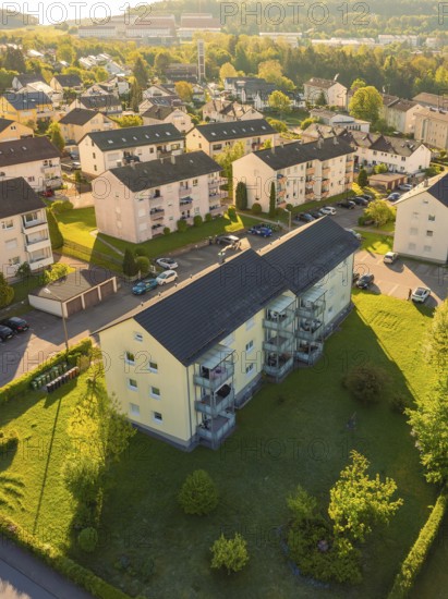 Sunlit apartment blocks with surrounding trees and streets, Calw, Black Forest, Germany