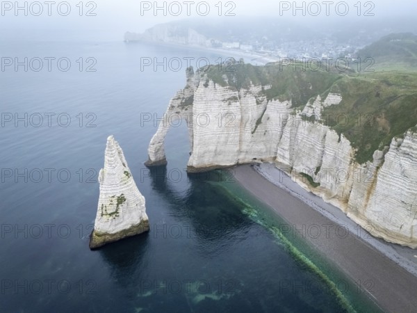 Aerial view of La Porte d'Aval and l'Aiguille on the Alabaster Coast in light fog, Etretat, Normandy, France