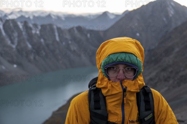 Mountaineer at Ala Köl mountain lake, in the Tien Shan Mountains, near Altyn Arashan, Kyrgyzstan