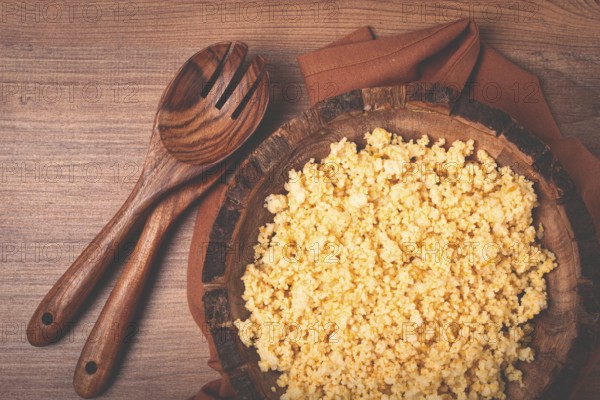 Cooked couscous, in a wooden bowl, top view, no people
