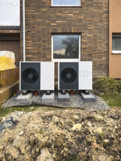 2 heat pumps are installed on an apartment block in a front garden, Hilden, Germany