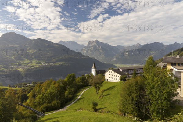 View of Amden with St Gallus church above Lake Walen, in the background Filzbach, Weesen and mountains, Amden, St. Gallen, Switzerland
