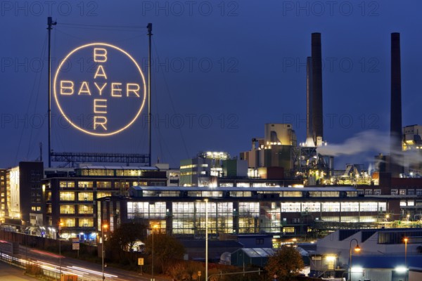 Bayer cross in the blue hour on the premises of Bayer AG, Leverkusen, Bergisches Land, North Rhine-Westphalia, Germany