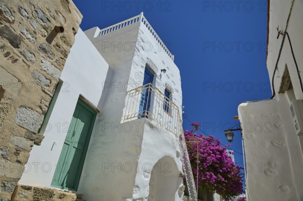 Traditional building with white walls and flowers under a bright blue sky, Chora, Astypalea, Dodecanese, Greek Islands, Greece