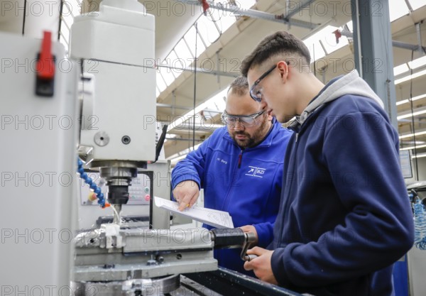 Remscheid, North Rhine-Westphalia, Germany - Trainees in metal professions, here with trainer at a machine tool, Vocational Training Centre of the Remscheid metal and electrical industry. - FOR EDITORIAL USE ONLY!