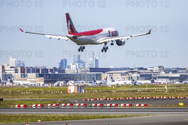 Fraport Airport in Frankfurt am Main. Aircraft landing against the backdrop of the banking district. Aircraft registration number: HL8227, T'Way, Air Airbus A330-200, Frankfurt am Main, Hesse, Germany
