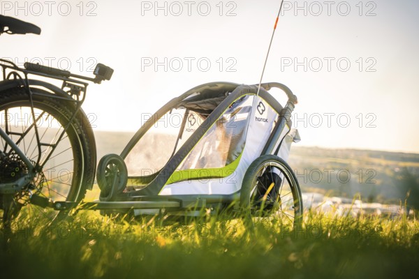 Side view of a bicycle trailer in a meadow with a wide view, e-bike, forest bike, Calw, district of Calw, Black Forest, Germany