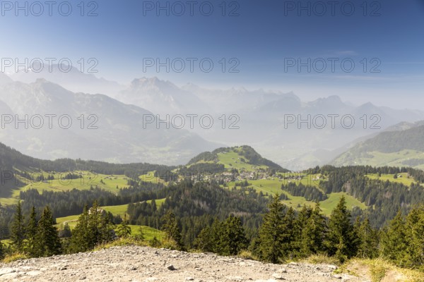 View from the summit of Flügenspitz to Arvenbüel with Chapf above Lake Walen, in the background Filzbach, Weesen and mountains in the fog, Amden, St. Gallen, Switzerland