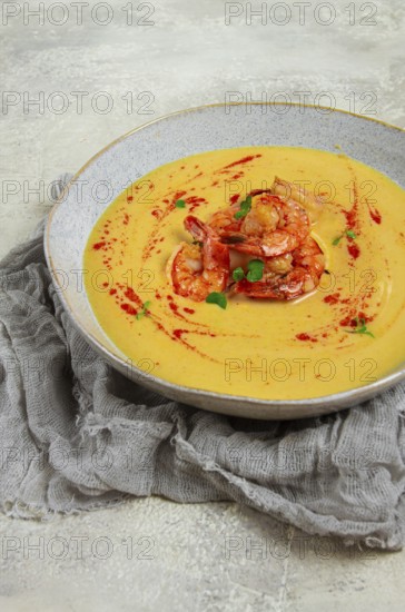 Pumpkin cream soup with shrimp, herbs and spices, homemade, no people
