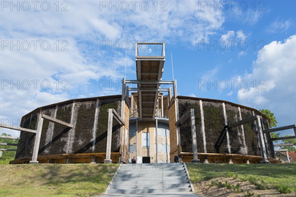 Round building made of wood and metal with stairs, blue sky and green landscape in the background, brine, graduation tower, spa town of Milomlyn, Milomlyn, Liebemühl, Warmia-Masuria, Poland