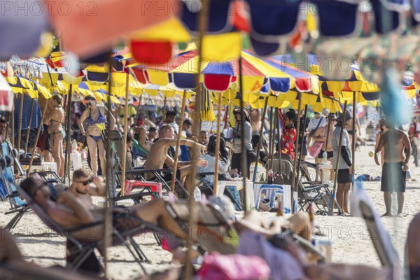 Overtourism in Thailand. Mass tourism on the sandy beach of Patong, the deckchairs are packed closely together. The beach stretches for around three kilometres along the Indian Ocean. Patong, Kathu, Phuket Island, Thailand