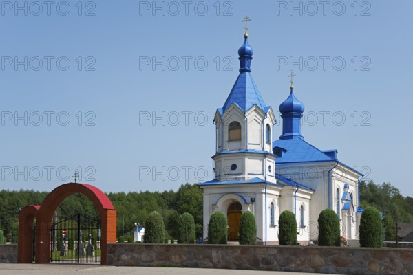 Orthodox church with blue roof and magnificent archway, surrounded by green landscape, Orthodox Church of the Assumption of the Virgin Mary, Dubiny, Podlaskie Voivodeship, Podlaskie, Poland