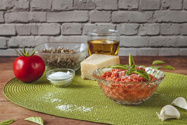 Food photography, making tomato pesto, with tomatoes (Solanum lycopersicum), salt, sunflower (Helianthus annuus) seeds, sunflower oil, basil (Ocimum basilicum), Parmesan cheese, garlic (Allium sativum)