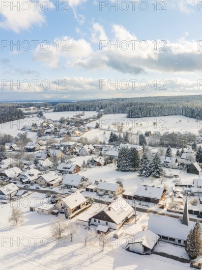 Snowy village view with houses and forest under a cloudy sky, Oberreichenbach, Black Forest, Calw County, Germany
