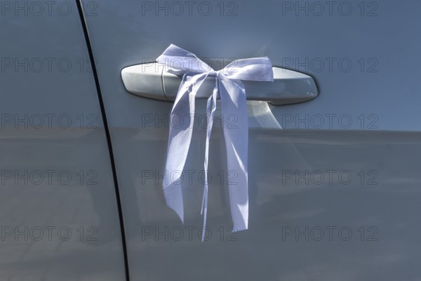 White ribbon on the door handle of a wedding car, Mecklenburg-Vorpommern, Germany