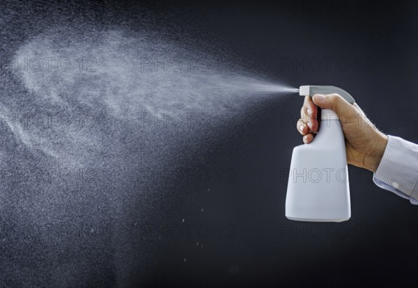 A man sprays a liquid into the air in Berlin, 09/08/2024