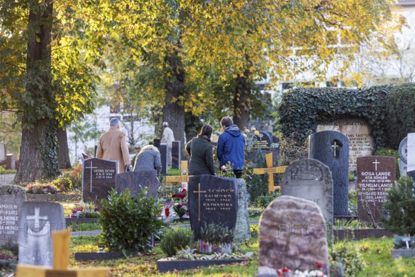 All Saints' Day at the Bergfriedhof cemetery in Stuttgart. Catholics commemorate their deceased relatives. Grave decorations and candles. Stuttgart, Baden-Württemberg, Germany