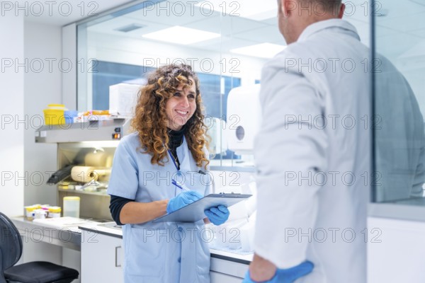 Scientists writing data working in a research laboratory in an hospital