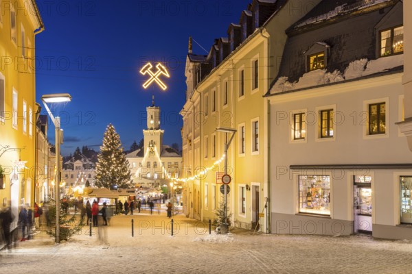 Christmas market with town hall and Christmas tree at the blue hour in Schneeberg, Erzgebirge, Saxony, Germany