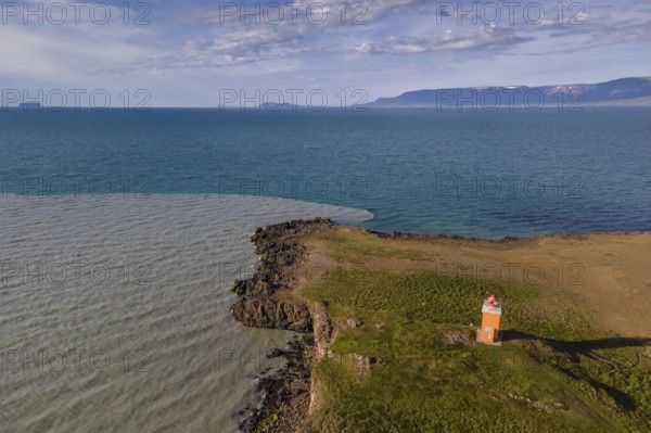 Drone picture, aerial view, lighthouse Hegranesviti, Hegranes, peninsula Landsendi, in the background island Drangey, near Sauðárkrokur, Skagafjörður, Iceland