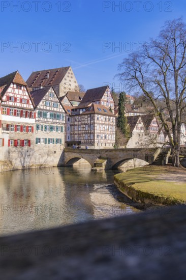 Old bridge over a river with half-timbered houses and clear sky in the background, Schwäbisch Hall, Germany