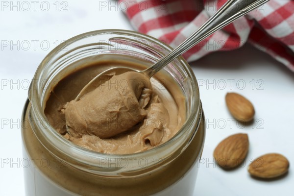 Almond cream in jar with spoon, almond spread