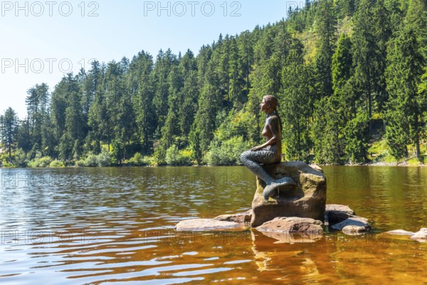 Mermaid sculpture on the lake in summer at Mummelsee, Black Forest, Germany