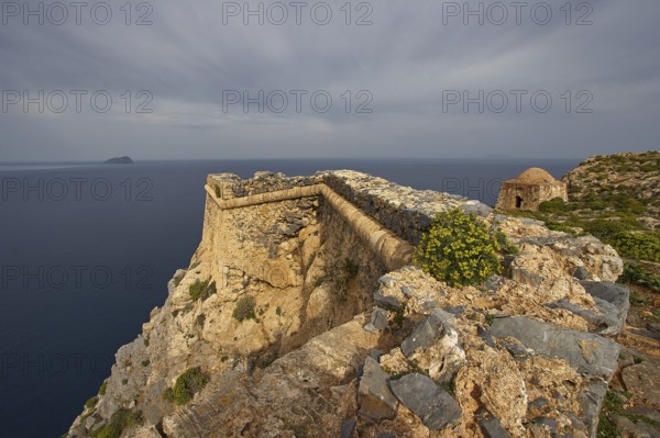 Venetian sea fortress Gramvoussa, morning light, cloudy sky, fortress walls, Pontikos Island, yellow spherical flowering perennial, square defence defence tower, Gramvoussa Peninsula, Pirate's Bay, Balos, Tigani, Western Crete, Crete Island, Greece