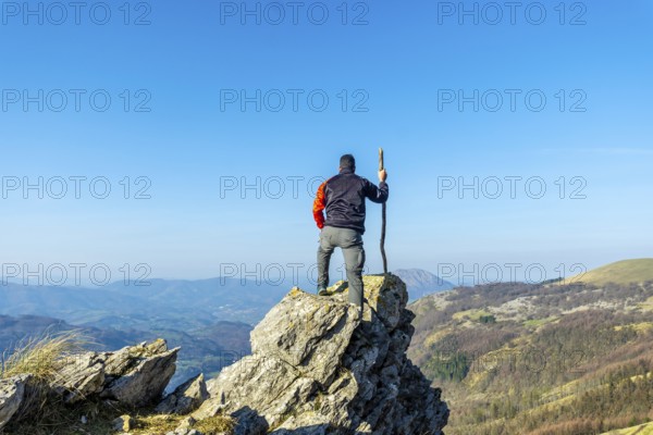 A man on the top of Mount Ernio or Hernio in Gipuzkoa at sunset, Basque Country