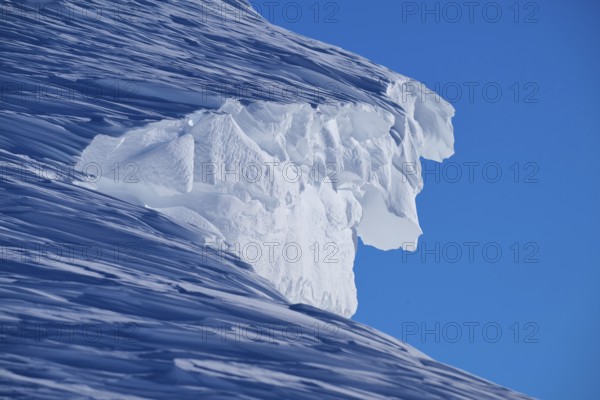 Close-up of a snow cornice under a clear blue sky, Gemmi Pass, Plattenhörner, Leukerbad, Leuk, Valais, Switzerland