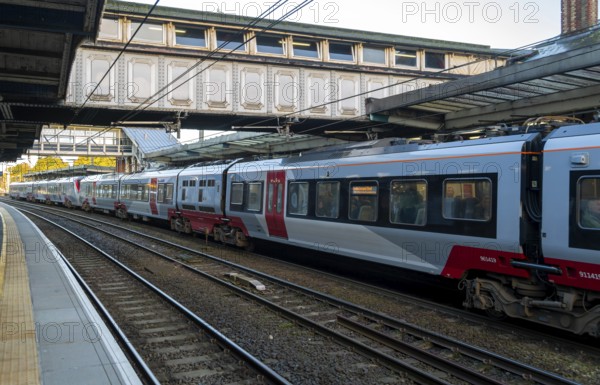 Carriages of long inter-city train at railway station platform, Ipswich, Suffolk, England, UK